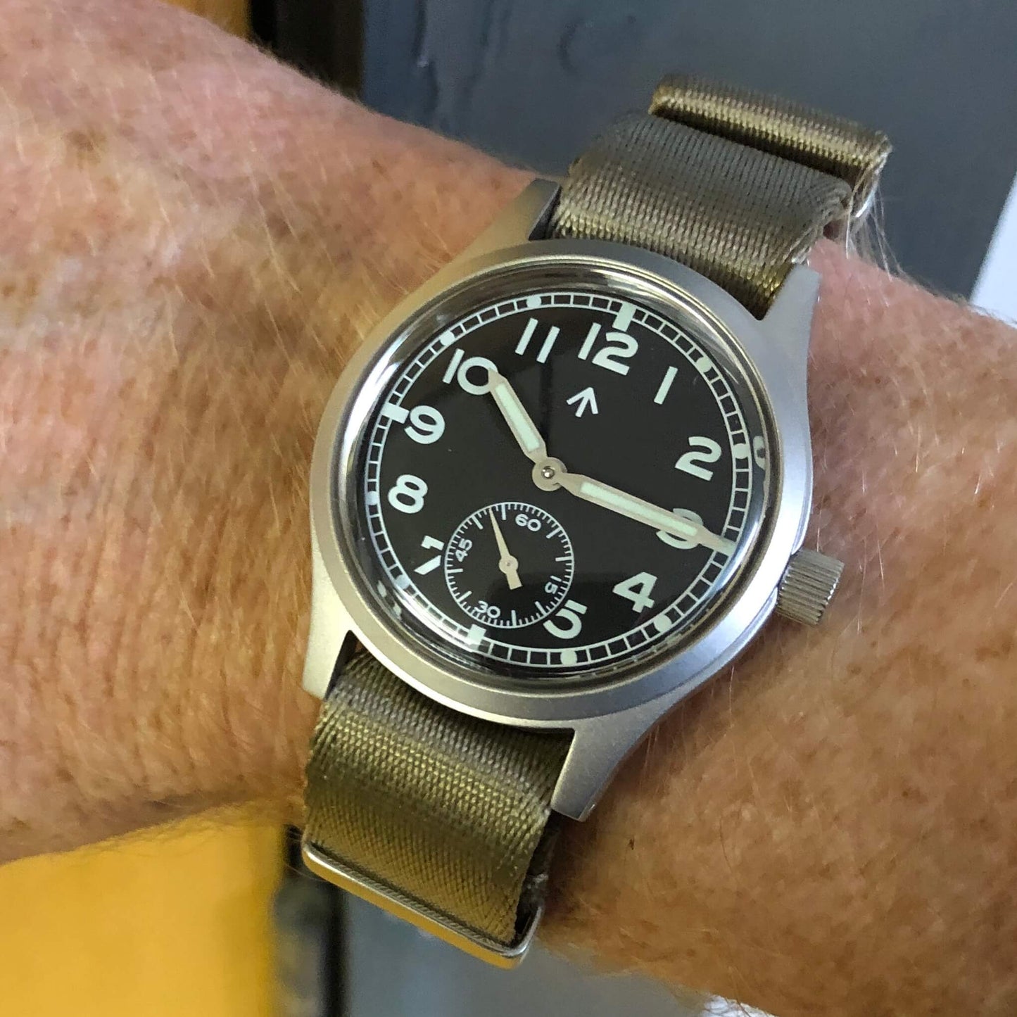 Enoksen Fly E03 36mm watch with black dial worn on a wrist size 18cm, showcasing the proportions and military case shape make it wear slightly larger than the numbers suggest.