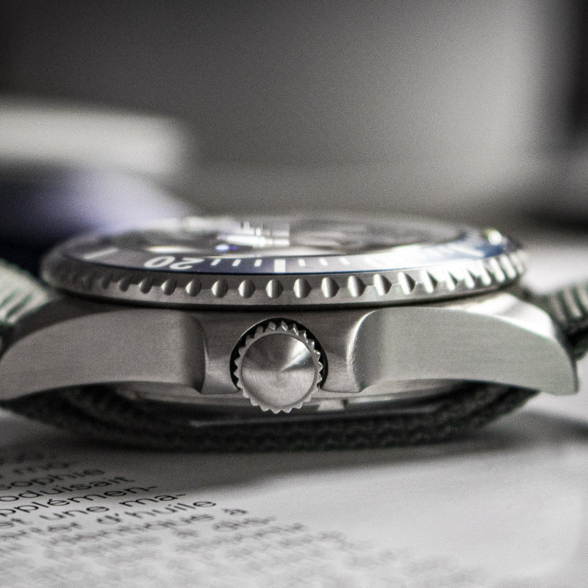 Close-up of a silver watch on a blurred background