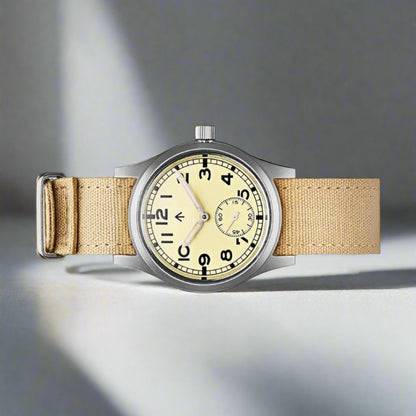 Aeschbach x Enoksen 'Fly' E03/T Dirty Dozen Automatic watch, 36mm, cream dial, shown with  a beige Canvas single pass strap.