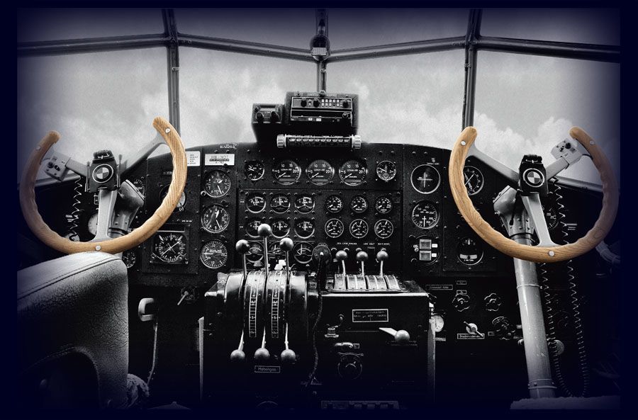 View from a cockpit in an old airplane. Wood stearing wheels.