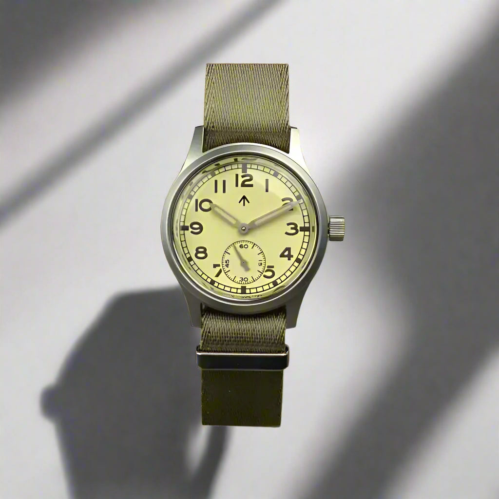 Aeschbach x Enoksen 'Fly' E03/T Dirty Dozen Automatic watch, 36mm, cream dial, shown with  a Khaki Seatbelt NATO strap.