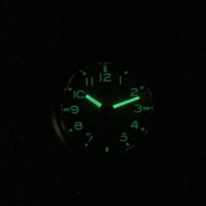 Aeschbach x Enoksen 'Fly' E03/T watch in darkness showcasing the C3 Super-Luminova effect.