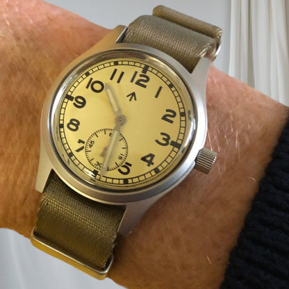 Aeschbach x Enoksen 'Fly' E03/T watch worn on a wrist, showcasing its classic military-inspired design.