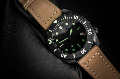 Watch with brown leather strap and black dial on a dark background