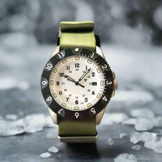 Enoksen Tactic E09/A tactical watch. Features a sandblasted steel case, sapphire crystal, and Swiss Tritium illumination. On a green NATO strap.
