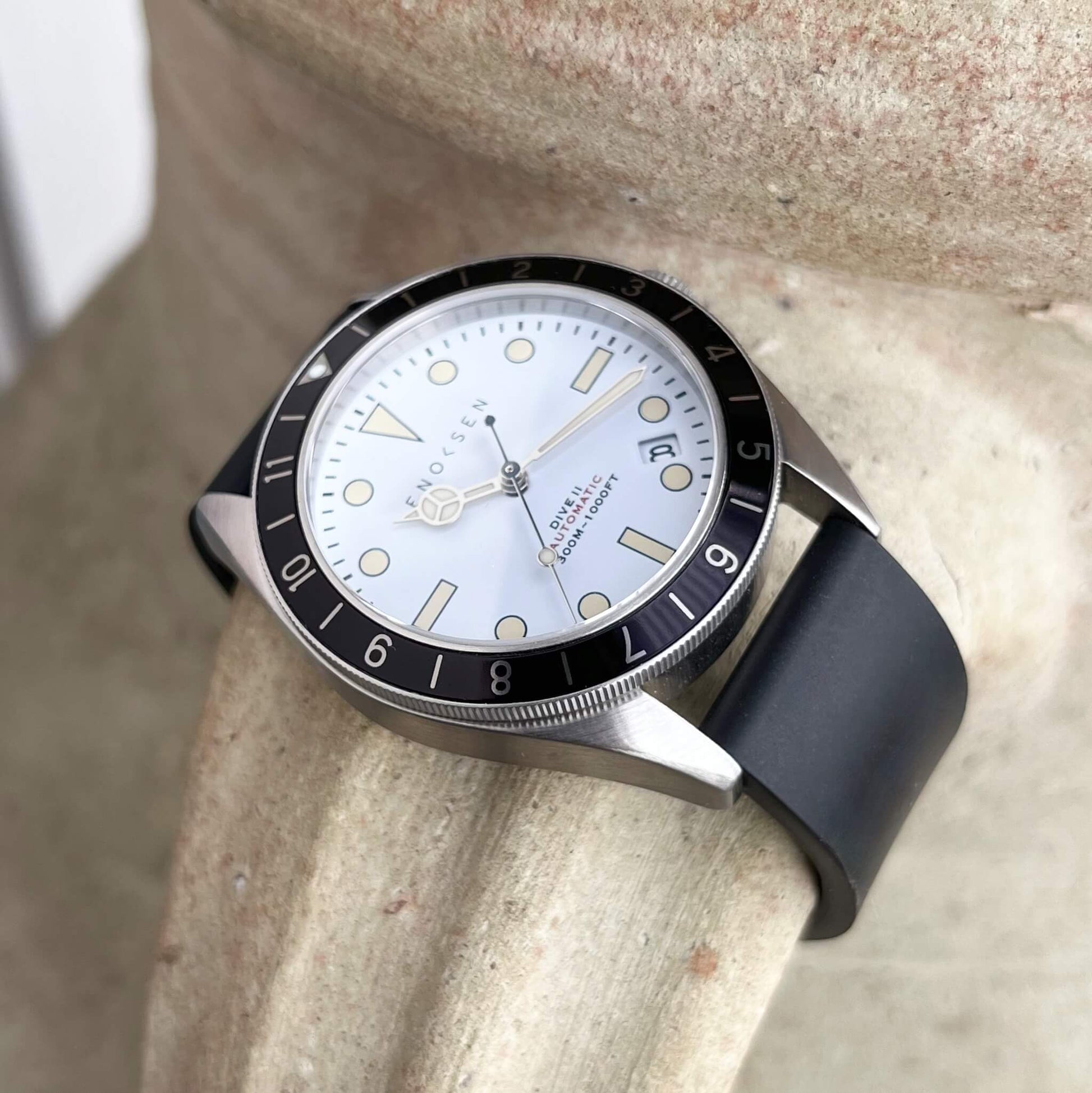 Dive II white dial edition on black rubber strap, angled view showing case profile and bezel.