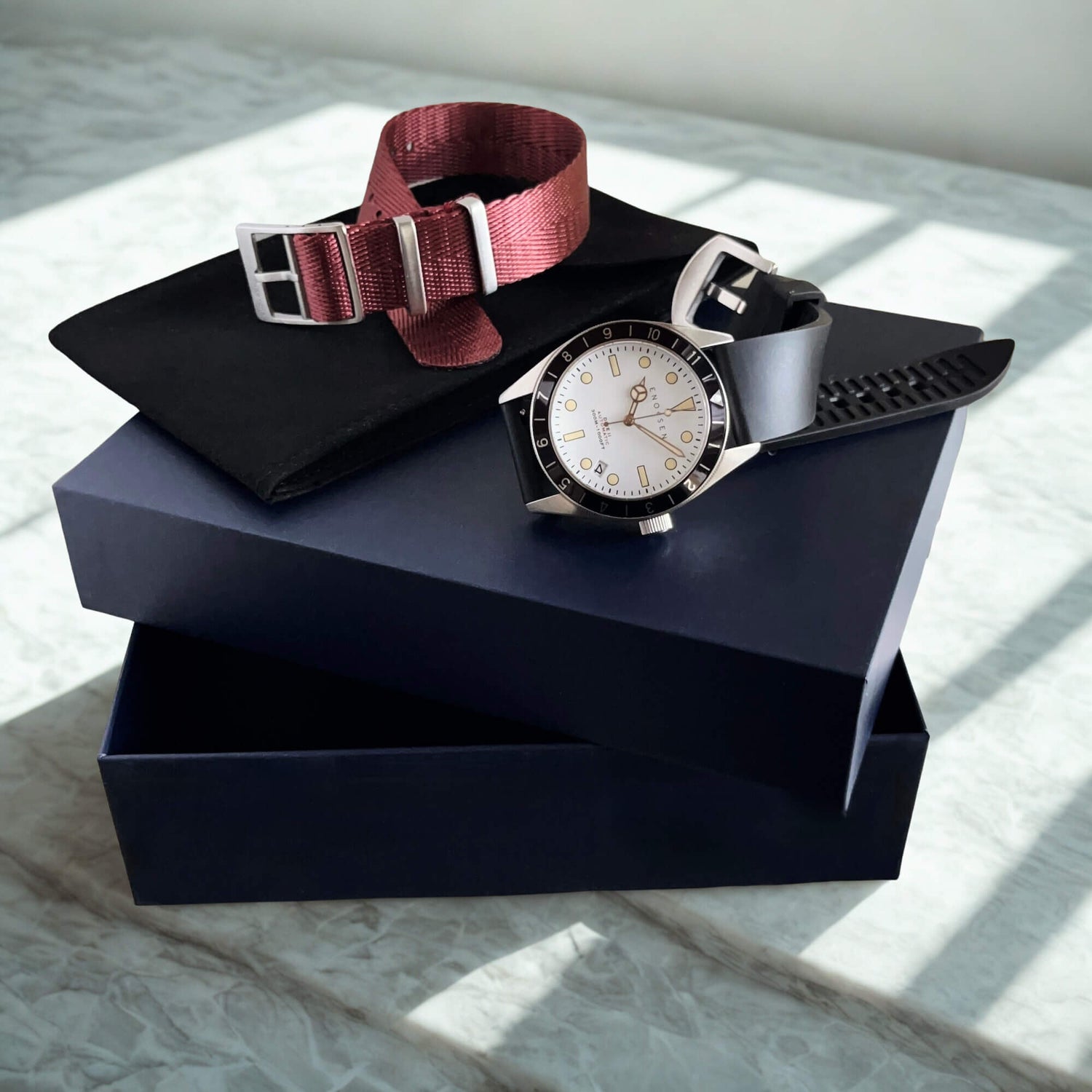 Dive II with presentation box, black rubber strap and burgundy herringbone woven strap.