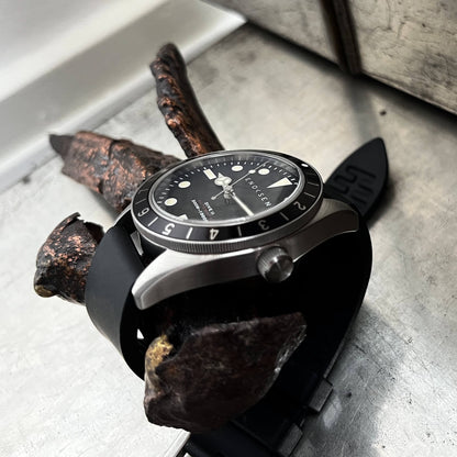 Dive II black dial on black rubber strap, angled view of the Dive II with black dial on black rubber strap, highlighting the domed sapphire crystal and 12-hour bezel.