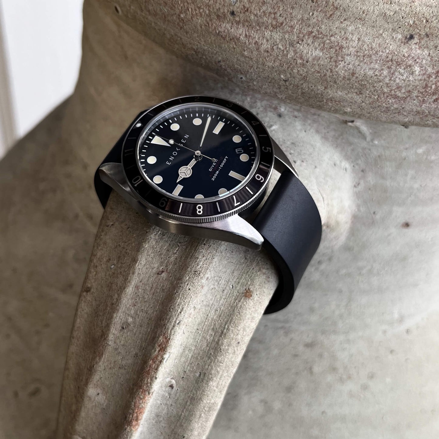 Dive II black dial edition on black rubber strap, angled view showing case profile and bezel.