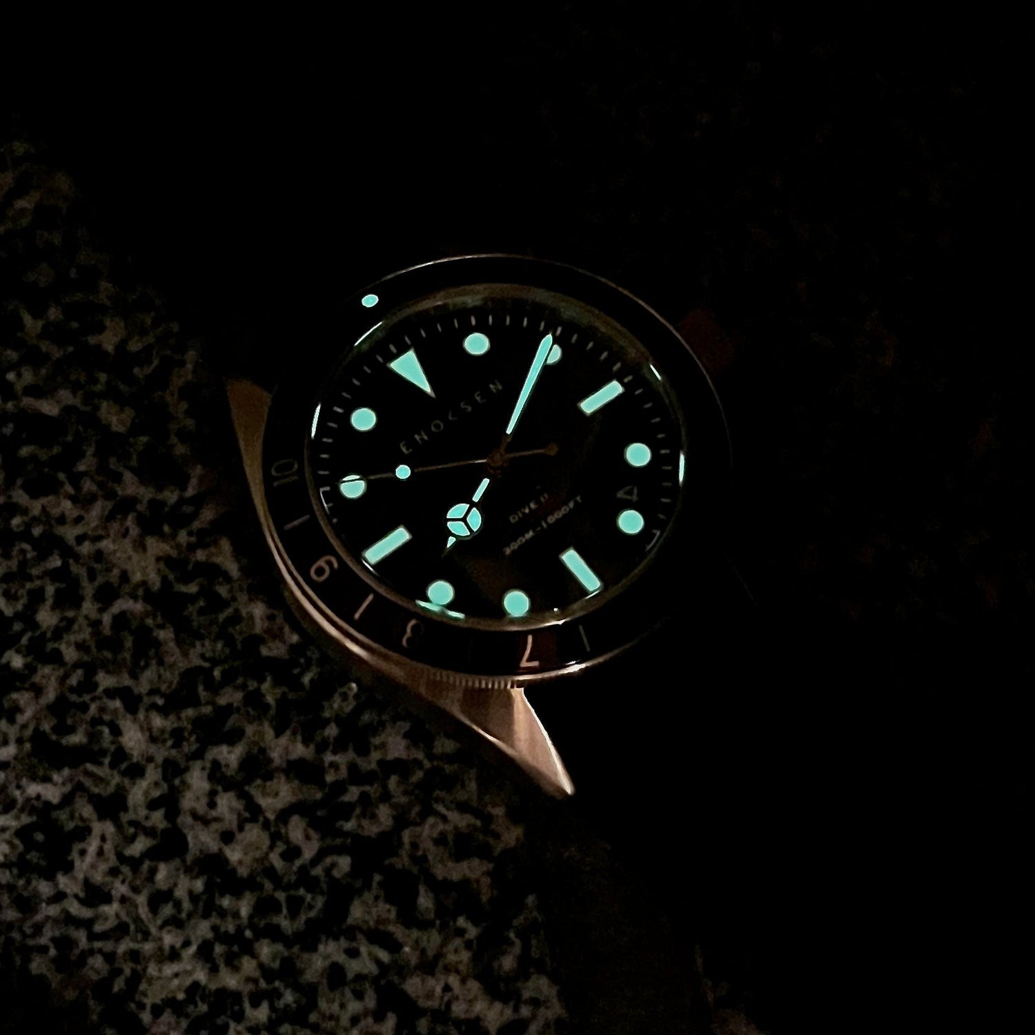 Swiss Super-LumiNova glow on hands, markers and bezel triangle in low light.