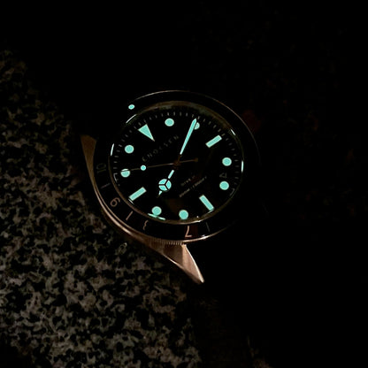 Swiss Super-LumiNova glow on hands, markers and bezel triangle in low light.