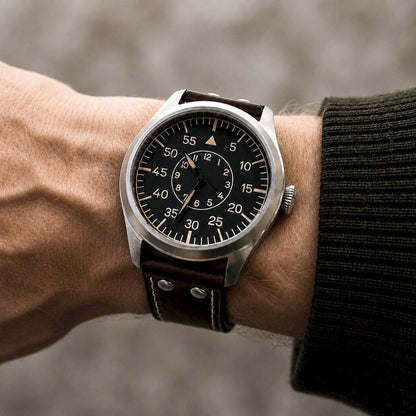 Enoksen FLY E03/B 46mm Beobachtungsuhr with black Baumuster B dial on a 19cm wrist with a green sweater.