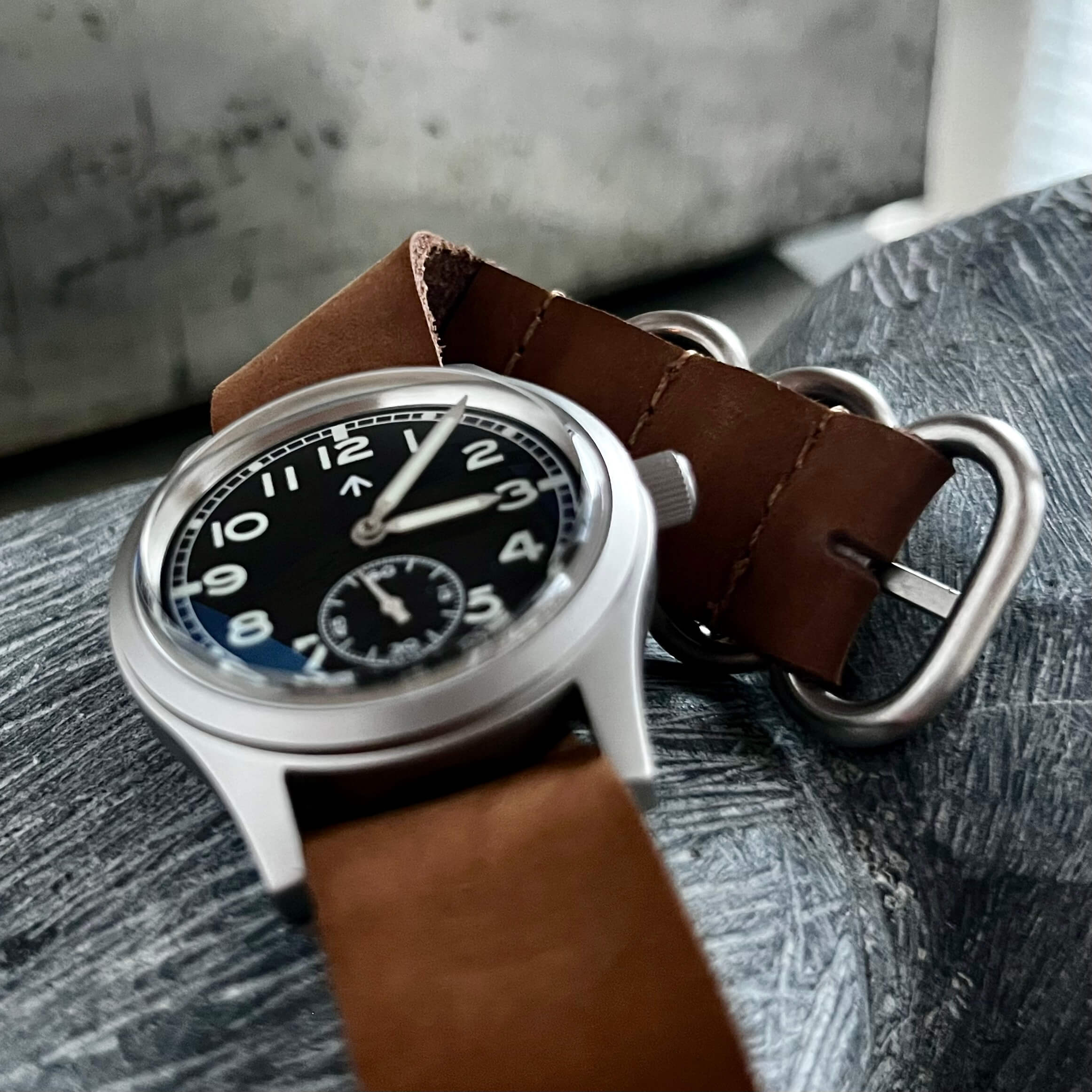 Enoksen FLYE03M Watch with included premium brown soft leather strap on a textured surface