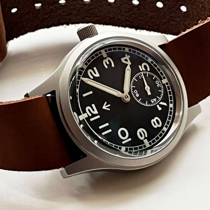 Dial close-up showing Arabic numerals and the railroad minute track on Enoksen Fly E03/M. Showcasing the Domed sapphire crystal. And how the iconic curved profile gives a classic look as well as a modern anti-reflective clarity and scratch resistance.