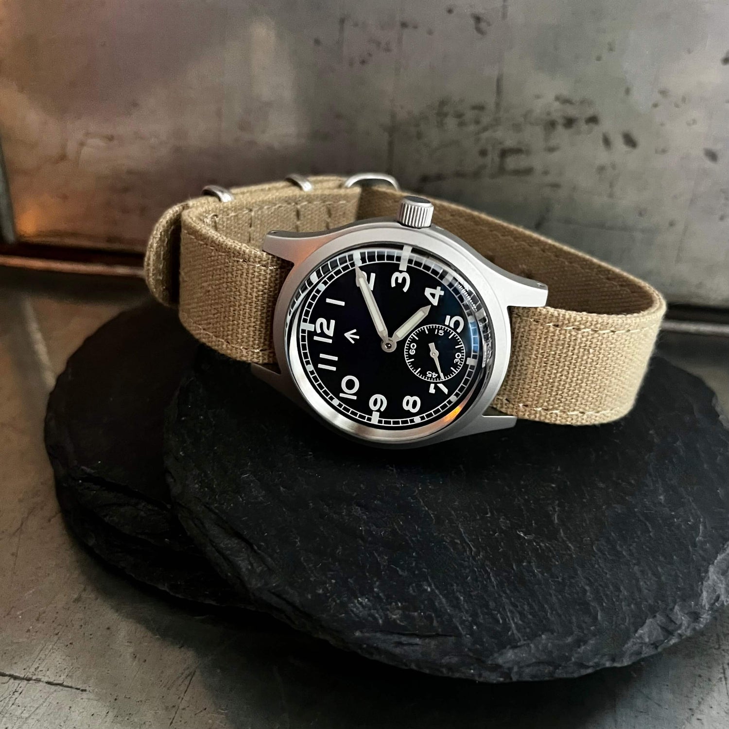 The Enoksen Swiss edition of Dirty Dozen watch on a Beige canvas strap that's also included with the watch. Showcasing the Light and casual strap offering an additional look out of the box.