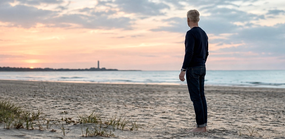 Man wearing an Enoksen watch on a beach at sunset